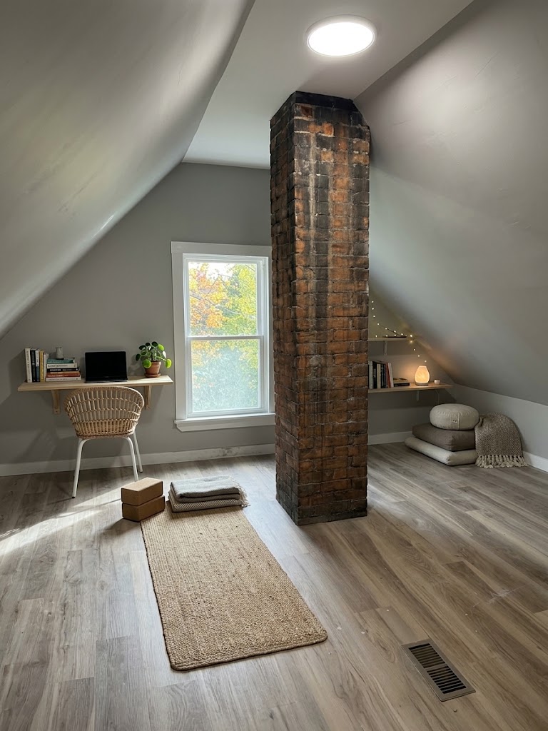Yoga and reading room with desk, yoga mat, and floor cushions